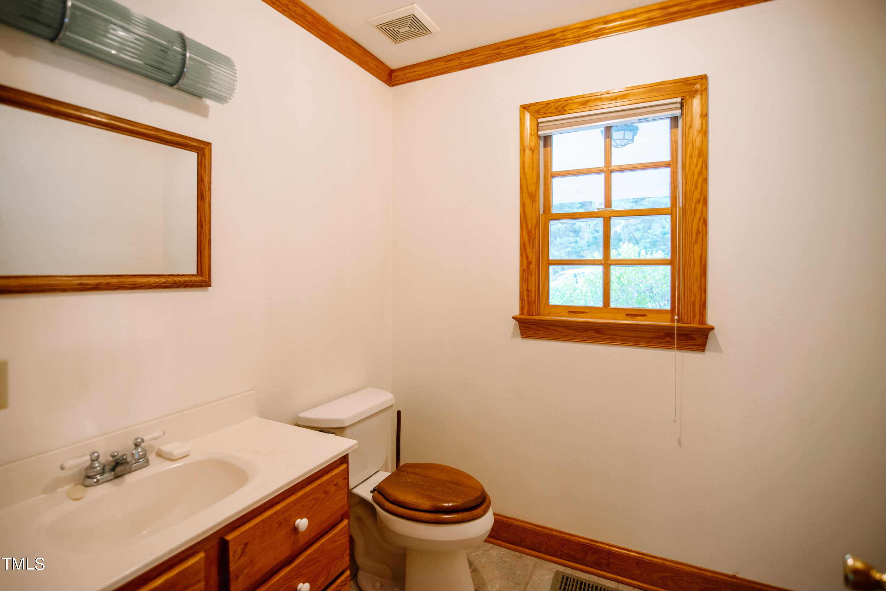 6700 Valley Lake Drive Raleigh, NC 27612 - Photo 13 of 23 a bathroom with a sink a toilet and a mirror