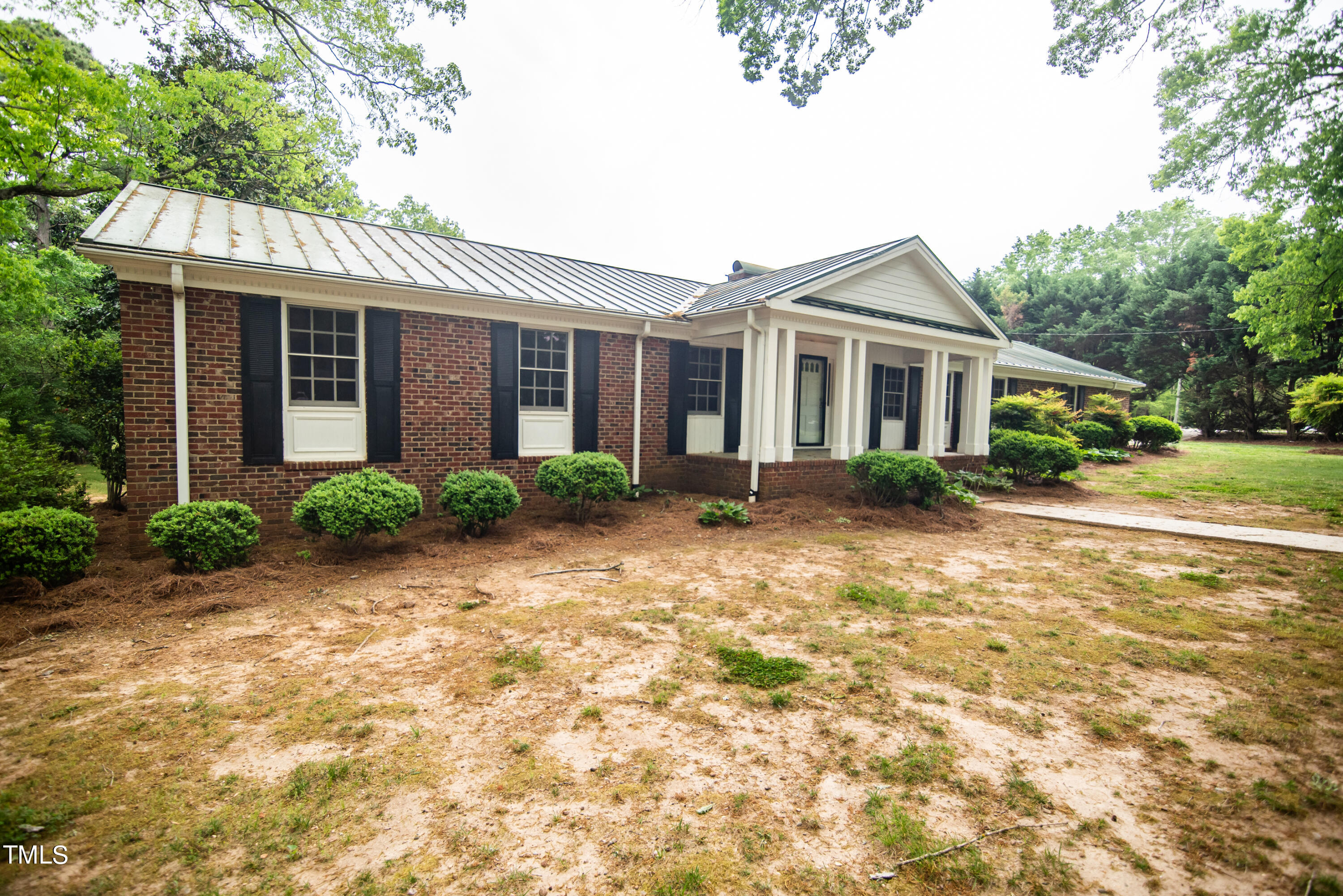6700 Valley Lake Drive Raleigh, NC 27612 - Photo 3 of 23 a front view of a house with garden