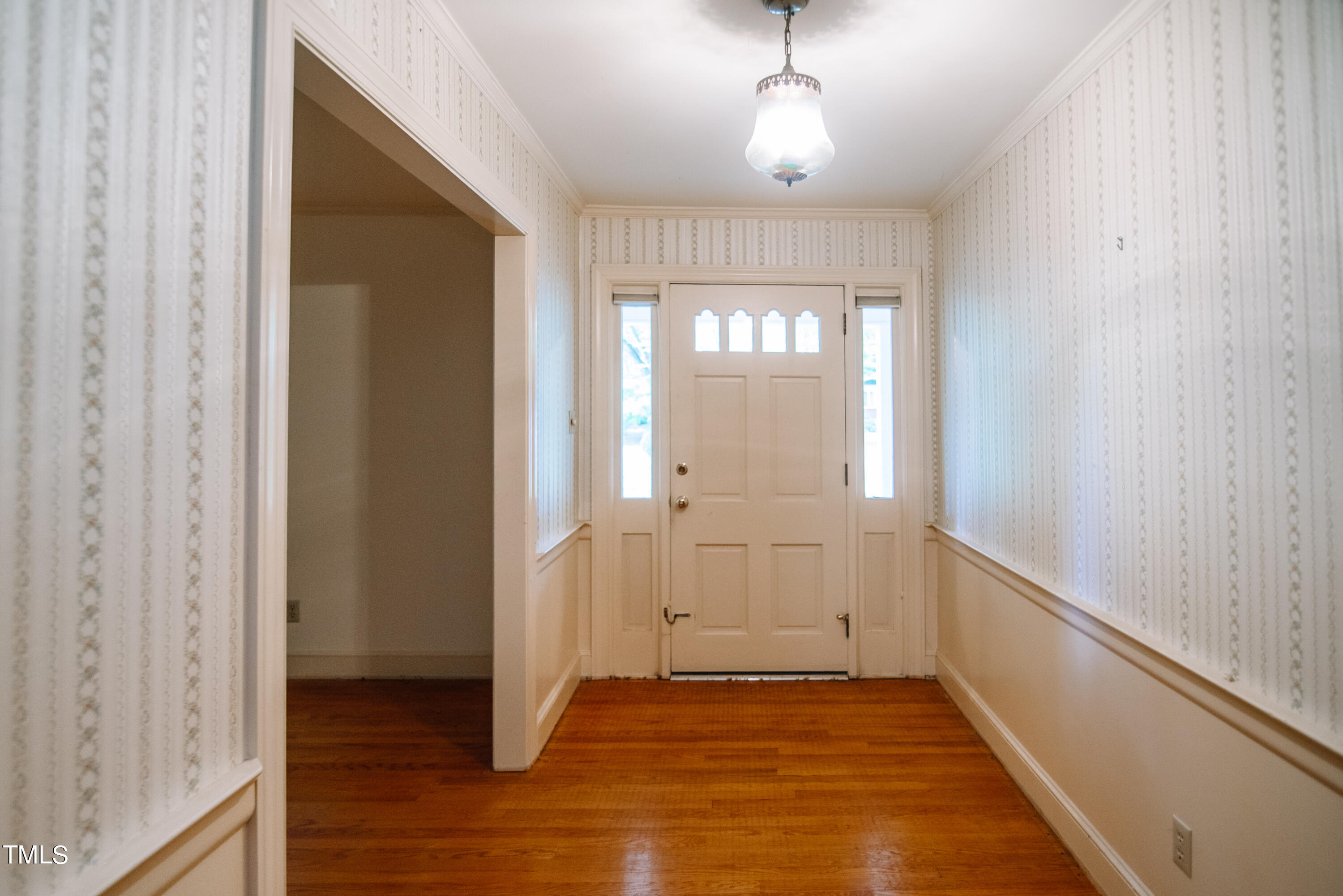 6700 Valley Lake Drive Raleigh, NC 27612 - Photo 5 of 23 a view of an empty room with wooden floor and a window