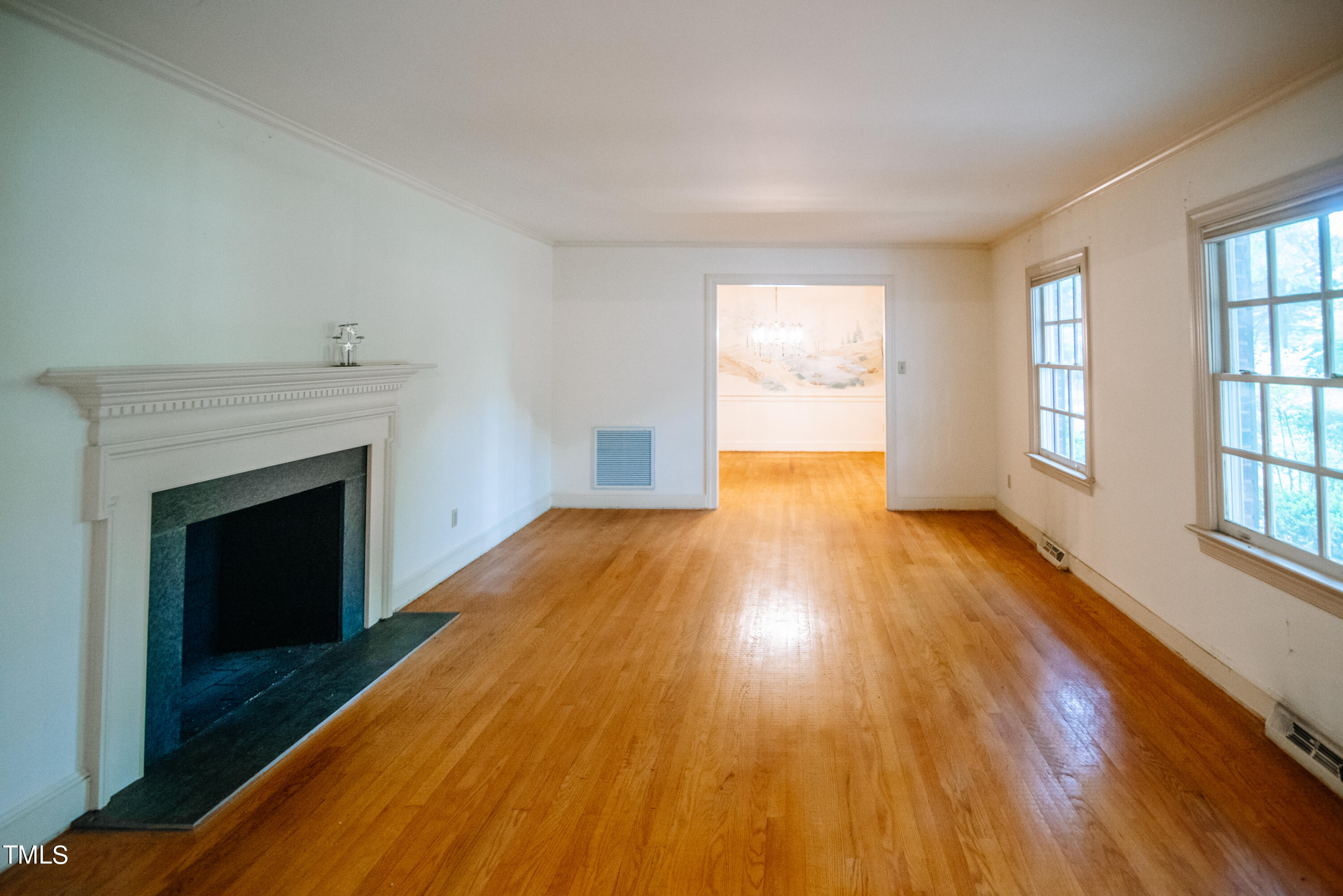 6700 Valley Lake Drive Raleigh, NC 27612 - Photo 6 of 23 wooden floor fireplace and windows in an empty room