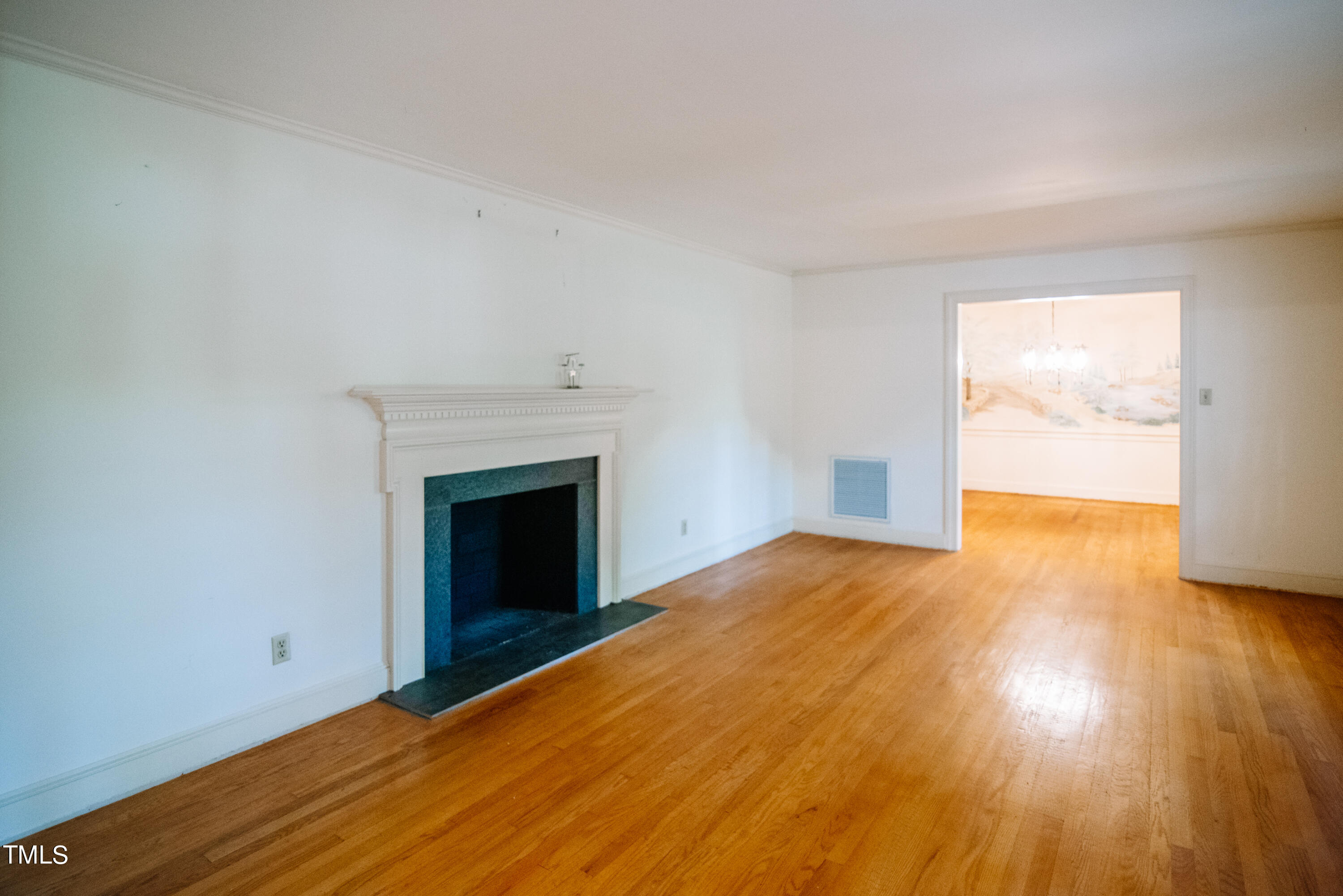 6700 Valley Lake Drive Raleigh, NC 27612 - Photo 7 of 23 a view of an empty room with wooden floor and a window