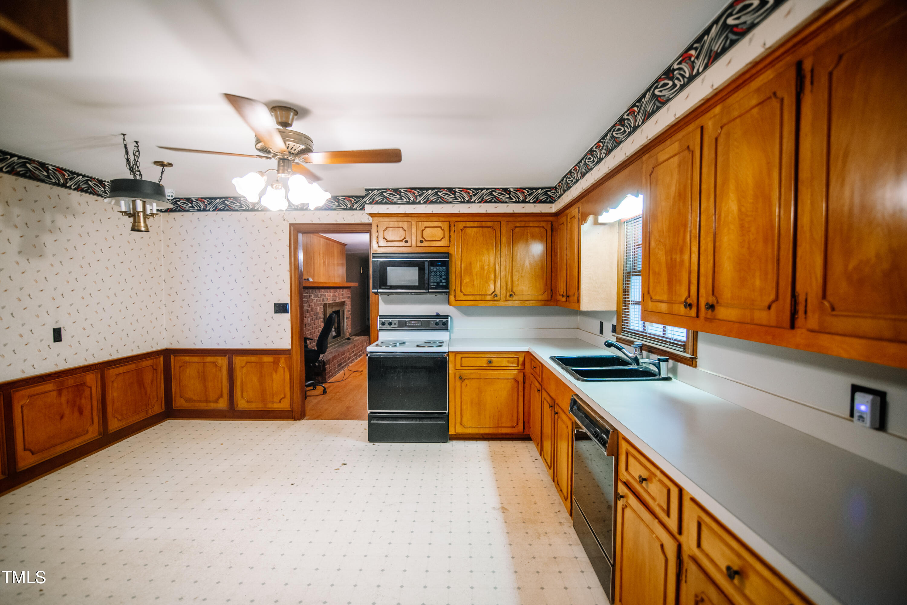 6700 Valley Lake Drive Raleigh, NC 27612 - Photo 9 of 23 a kitchen with stainless steel appliances granite countertop a sink stove and cabinets
