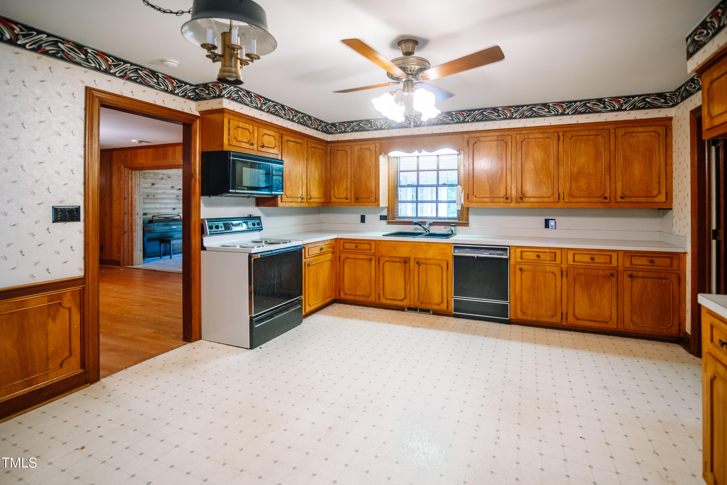 6700 Valley Lake Drive Raleigh, NC 27612 - Photo 10 of 23 a large kitchen with stainless steel appliances granite countertop a sink and a refrigerator