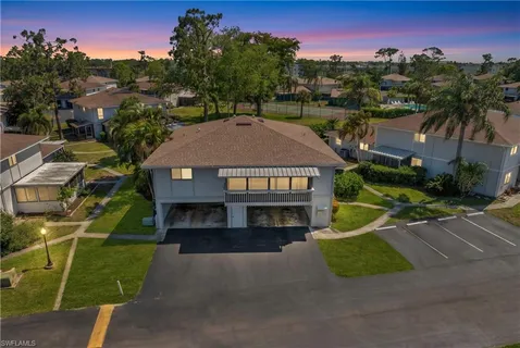 an aerial view of a house with a yard and lake view