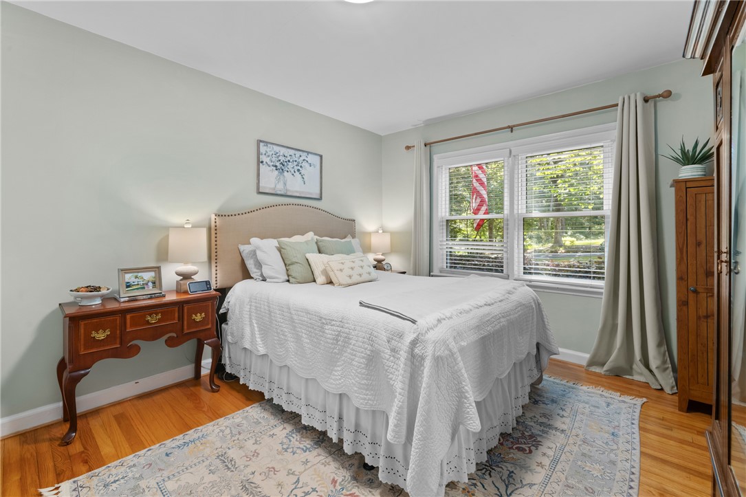 203 Augusta Road Clemson, SC 29631 - Photo 21 of 31 Well-lit and inviting, this comfortable primary bedroom offers ample natural light and polished hardwood flooring.