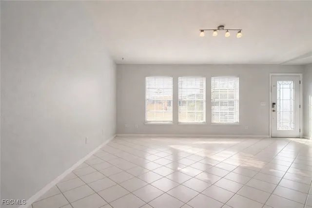 a kitchen with stainless steel appliances kitchen island granite countertop a stove a sink a refrigerator and white cabinets with wooden floor