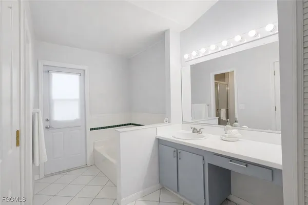 a bathroom with a bathtub and a sink