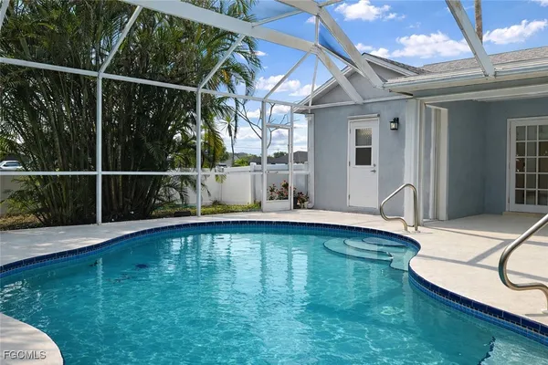 a view of pool with a yard