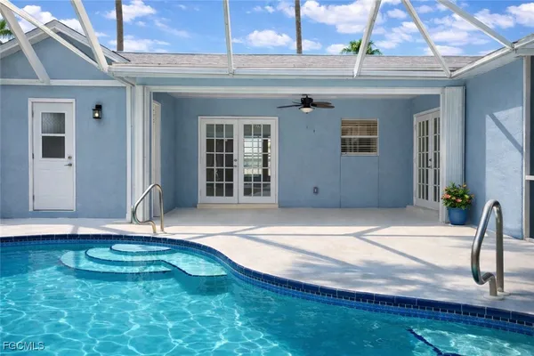 a view of a swimming pool with a patio and yard