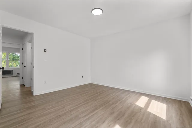 a view of an empty room and wooden floor