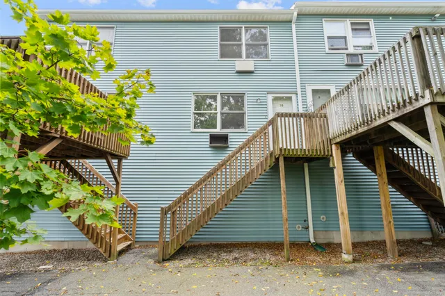 a view of a house with wooden stairs front