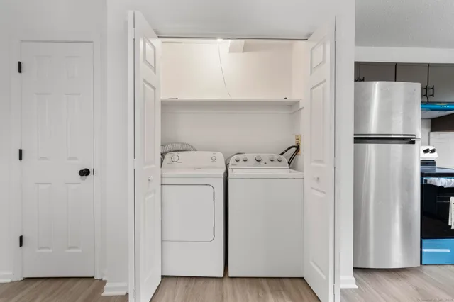 a utility room with cabinets washer and dryer