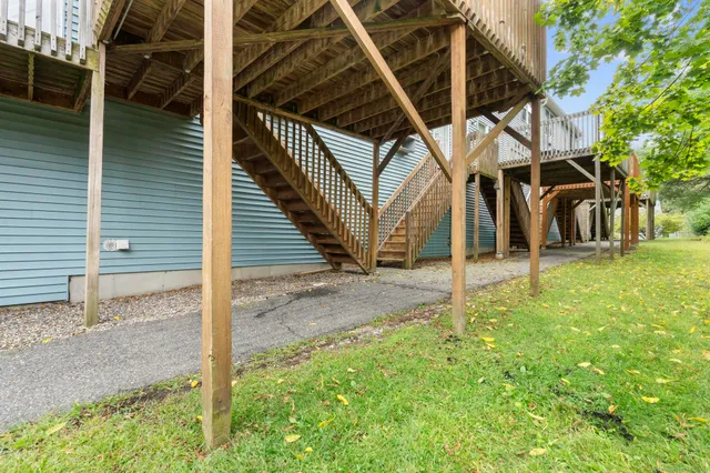 a view of a house with backyard and trees