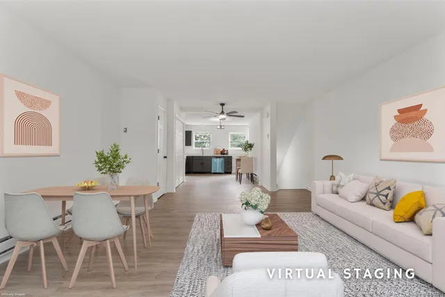 a living room with furniture and wooden floor