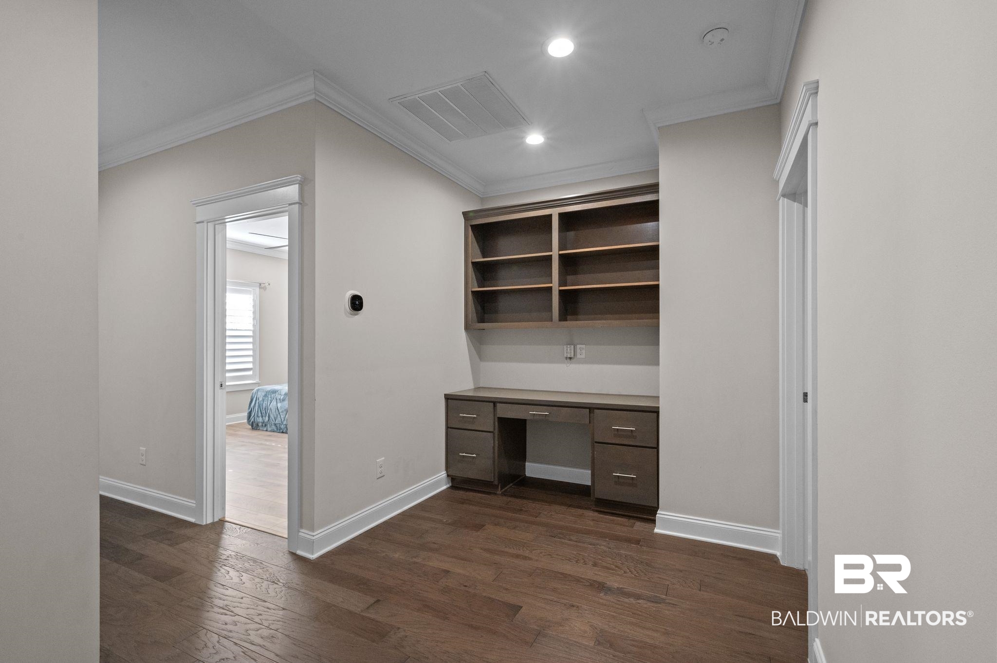 32194 Badger Court Daphne, AL 36527 - Photo 30 of 49 Unfurnished office featuring built in study area, dark wood finished floors, recessed lighting, and crown molding