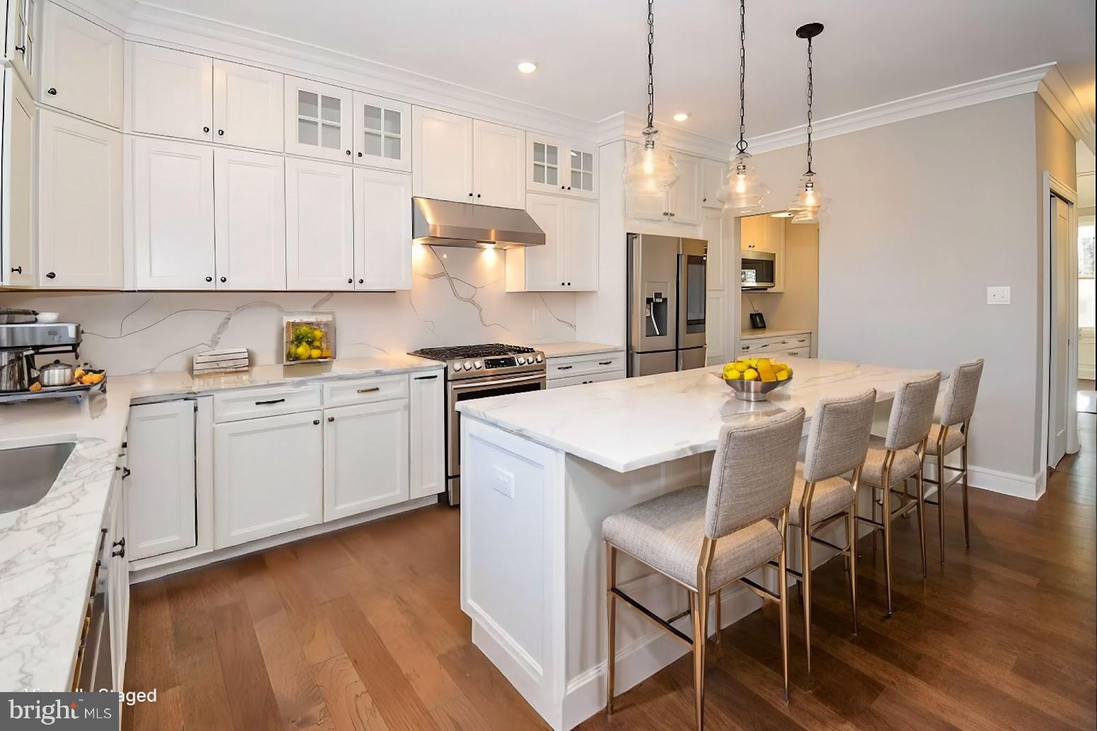 396 A Tavistock Boulevard Haddonfield, NJ 08033 - Photo 11 of 29 a kitchen with stainless steel appliances a white table chairs and a refrigerator