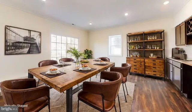 a table and chairs in a room with a window