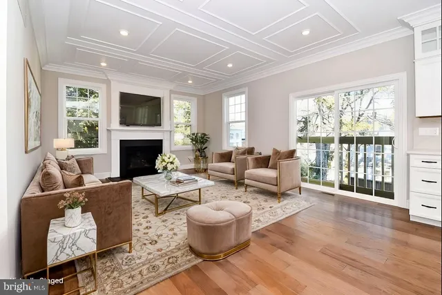 a living room with furniture fireplace and a large window