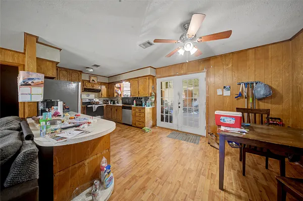 a living room with stainless steel appliances kitchen island granite countertop furniture and a kitchen view