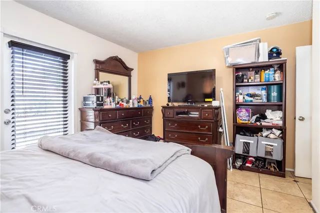 a bedroom with a bed and dresser