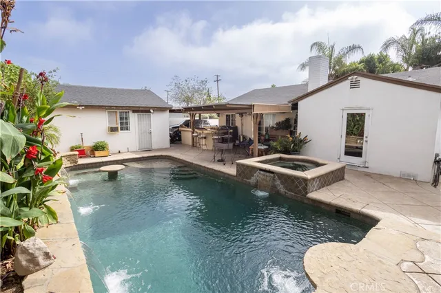 an aerial view of a house with a yard and sitting area
