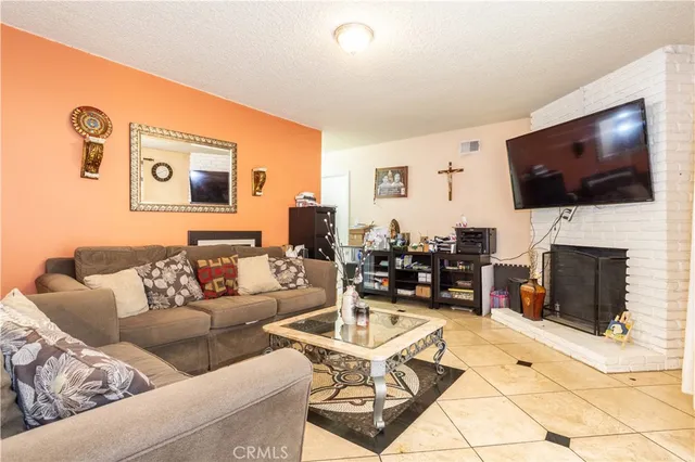 a view of a dining room with furniture and a chandelier
