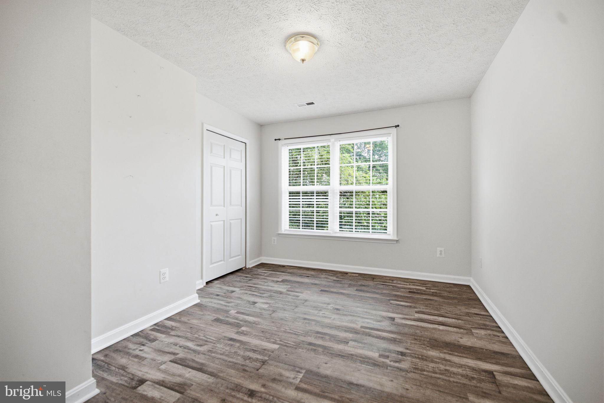 35338 Pheasant Ridge Road Locust Grove, VA 22508 - Photo 31 of 39 an empty room with wooden floor and windows