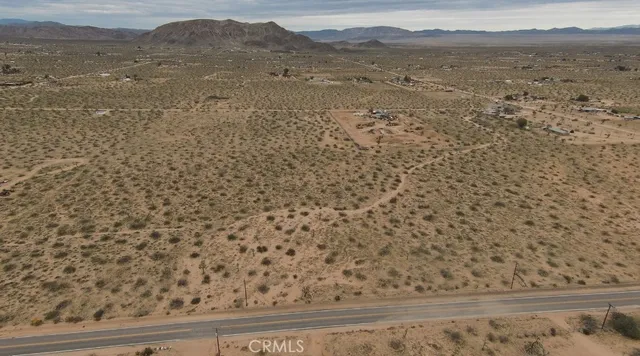 a view of a dry yard with mountains