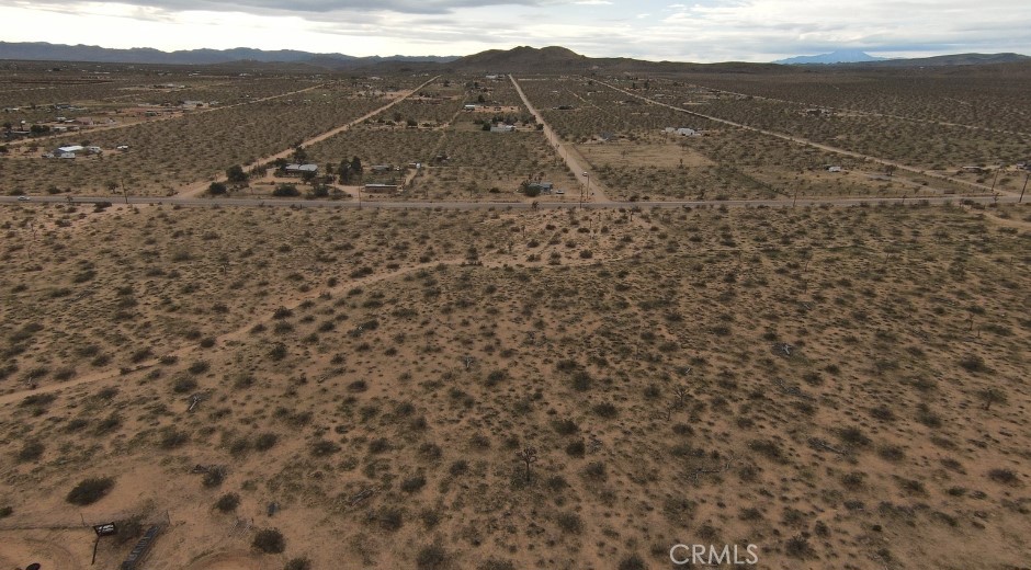 59520 Reche Road Landers, CA 92285 - Photo 3 of 11 a view of a dry yard with mountains
