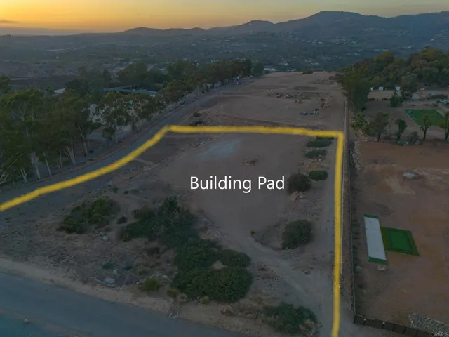 a view of a street with a big yard