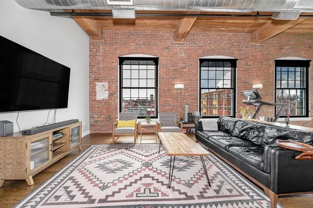 a large kitchen with stainless steel appliances granite countertop a lot of counter space and wooden floors