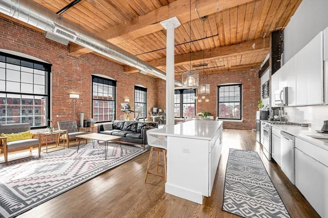 a kitchen with stainless steel appliances granite countertop a stove and a microwave