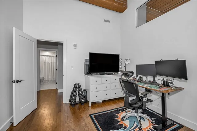 a view of a kitchen with a sink and wooden floor