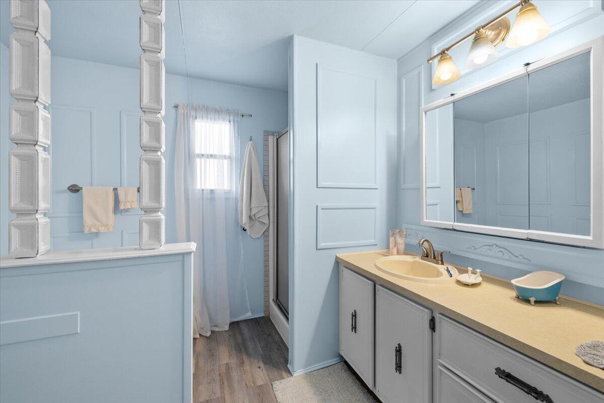301 Freeman Road, Unit 92 Central Point, OR 97502 - Photo 15 of 16 a spacious bathroom with a granite countertop sink and a mirror
