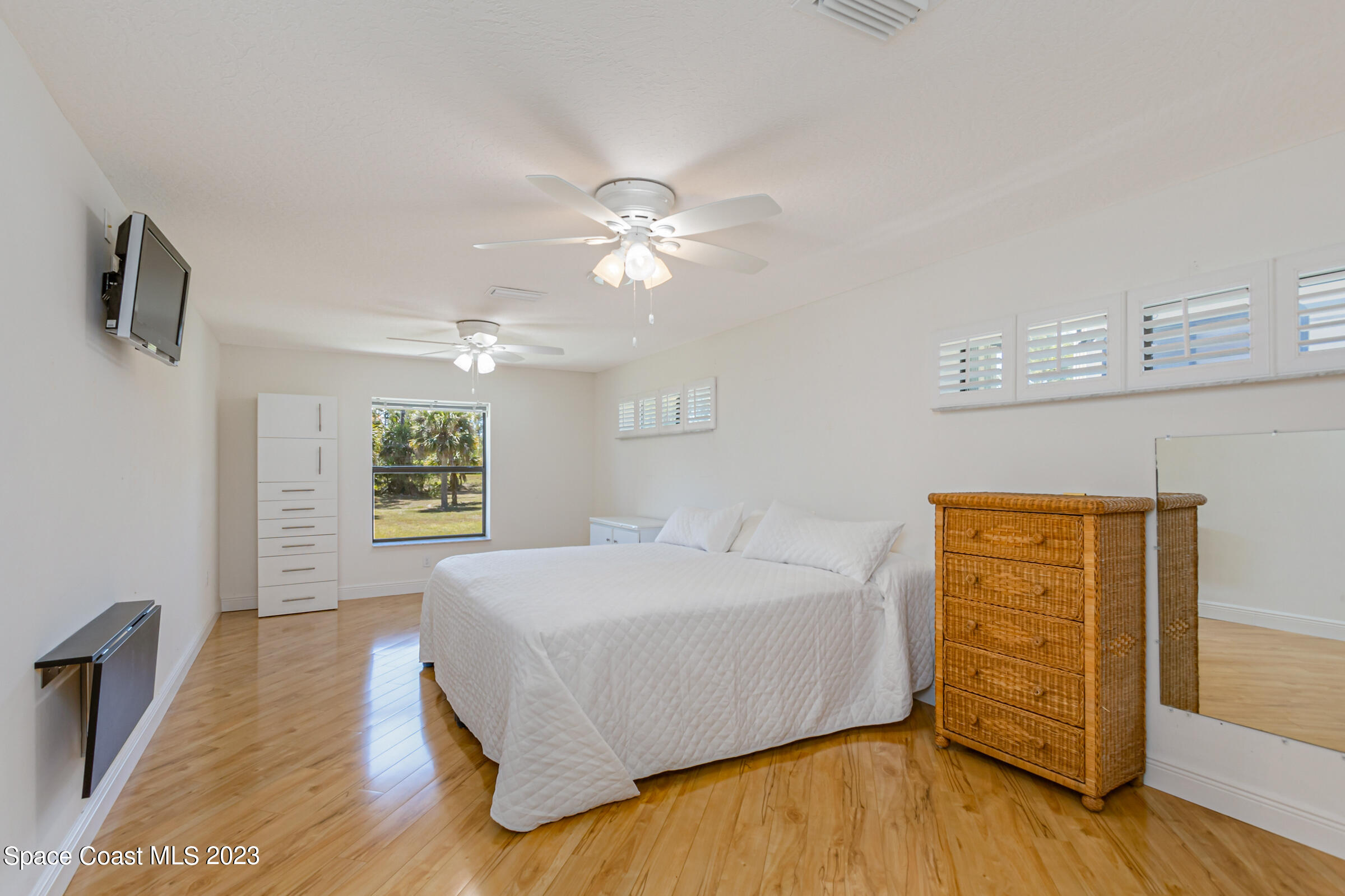 271 Deer Run Road Palm Bay, FL 32909 - Photo 37 of 61 a spacious bedroom with a bed and a chandelier
