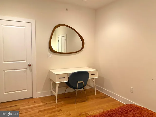 a bedroom with a bed and a mirror