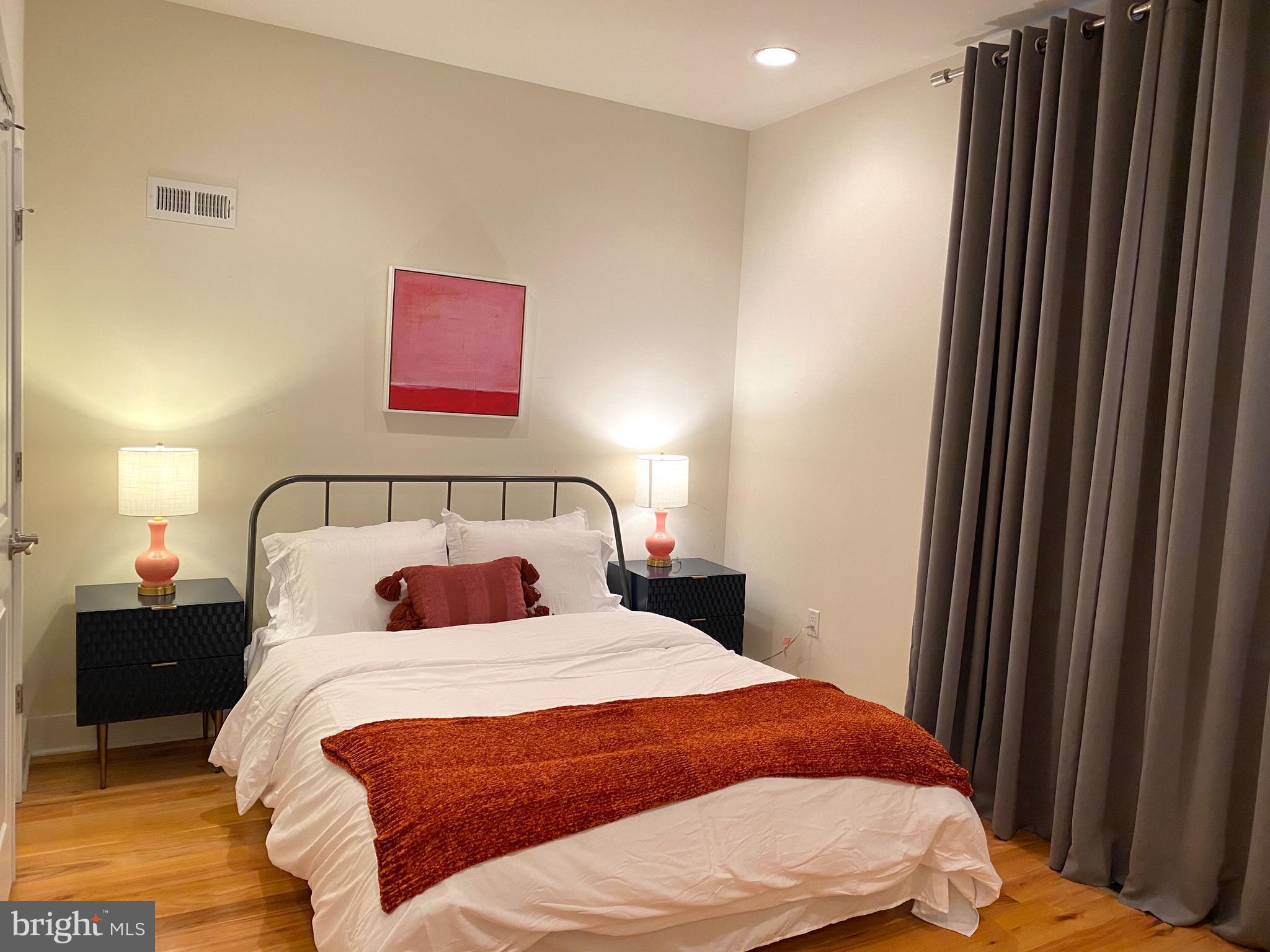 3304 Conrad Street Philadelphia, PA 19129 - Photo 19 of 29 a bedroom with a bed and a mirror