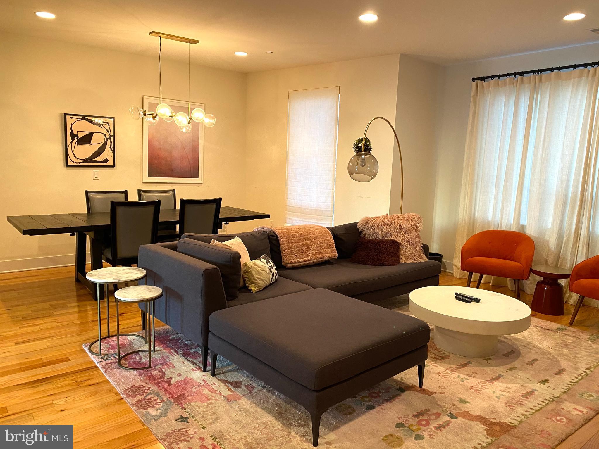 3304 Conrad Street Philadelphia, PA 19129 - Photo 3 of 29 a living room with furniture a rug and a chandelier