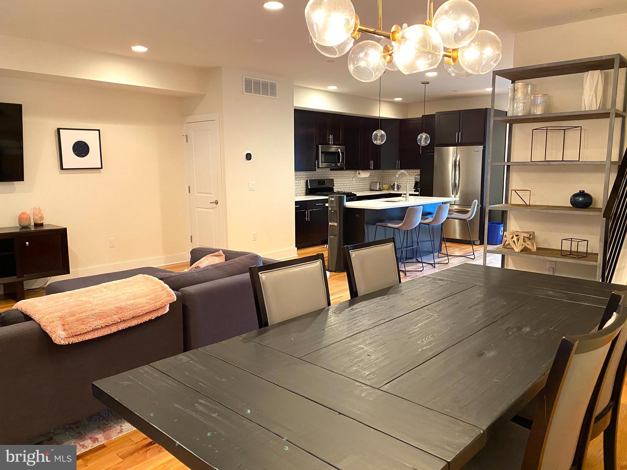 3304 Conrad Street Philadelphia, PA 19129 - Photo 10 of 29 a living room with stainless steel appliances kitchen island granite countertop furniture and a view of kitchen