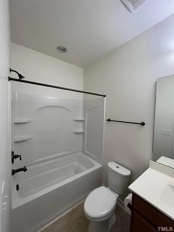 a bathroom with a toilet and a bath tub
