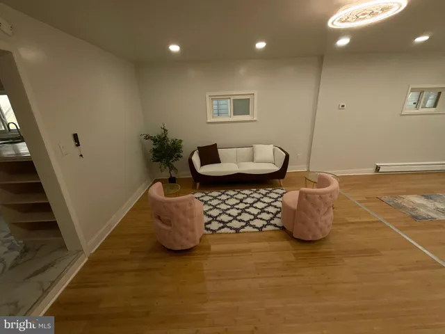a living room with furniture and a potted plant