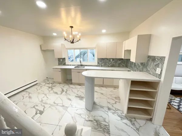 a kitchen with a table and chairs in it