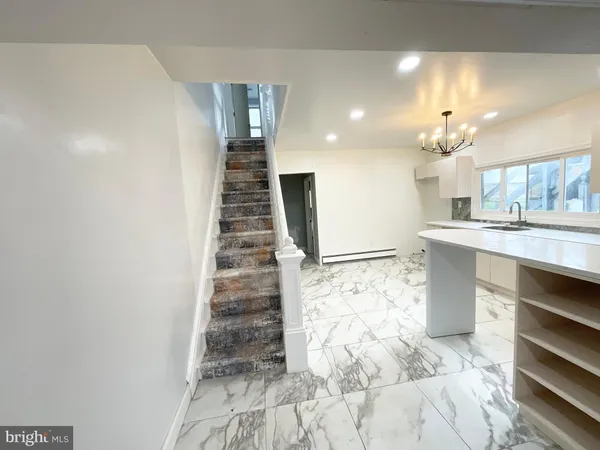 a view of kitchen with sink and refrigerator
