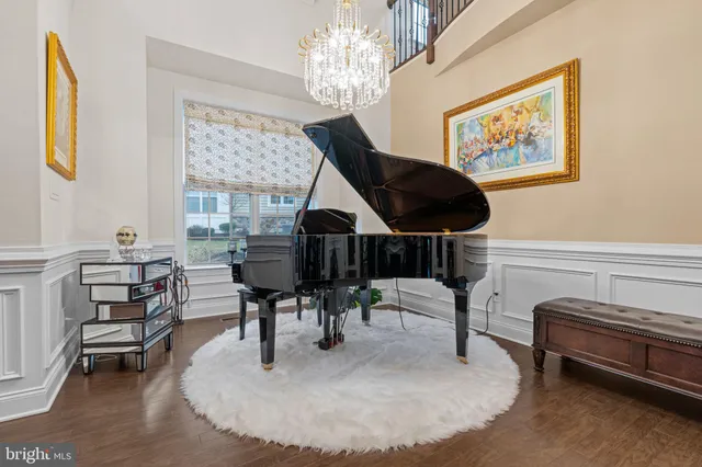 a kitchen with a dining table chairs sink and wooden floor