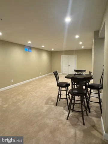 a view of a house with pool and sitting area