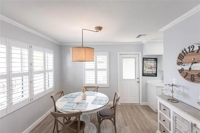 a view of a dining room with furniture and window