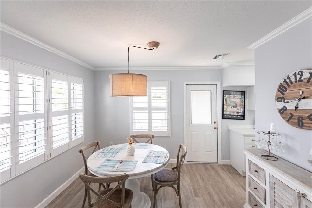 6020 Midnight Pass Road, Unit 30 Sarasota, FL 34242 - Photo 2 of 14 a view of a dining room with furniture and window