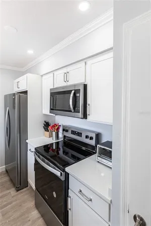 a kitchen with stainless steel appliances a stove microwave and refrigerator