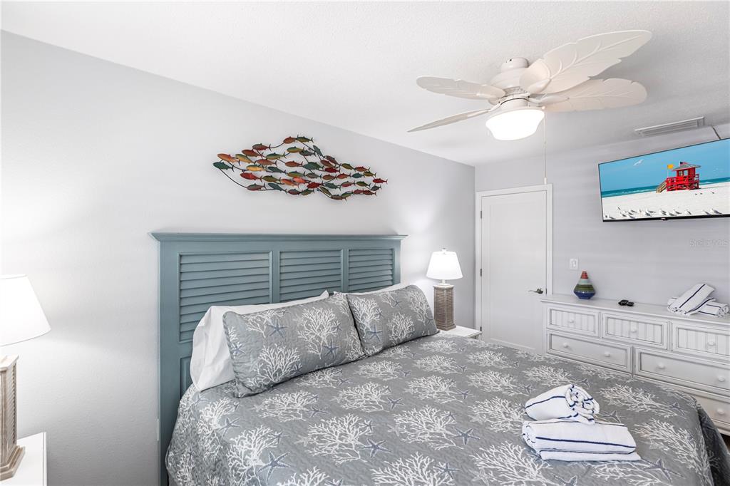 6020 Midnight Pass Road, Unit 30 Sarasota, FL 34242 - Photo 9 of 14 a bed room with a bed and a couch