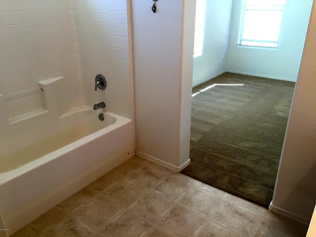 a bathroom with a bathtub and shower